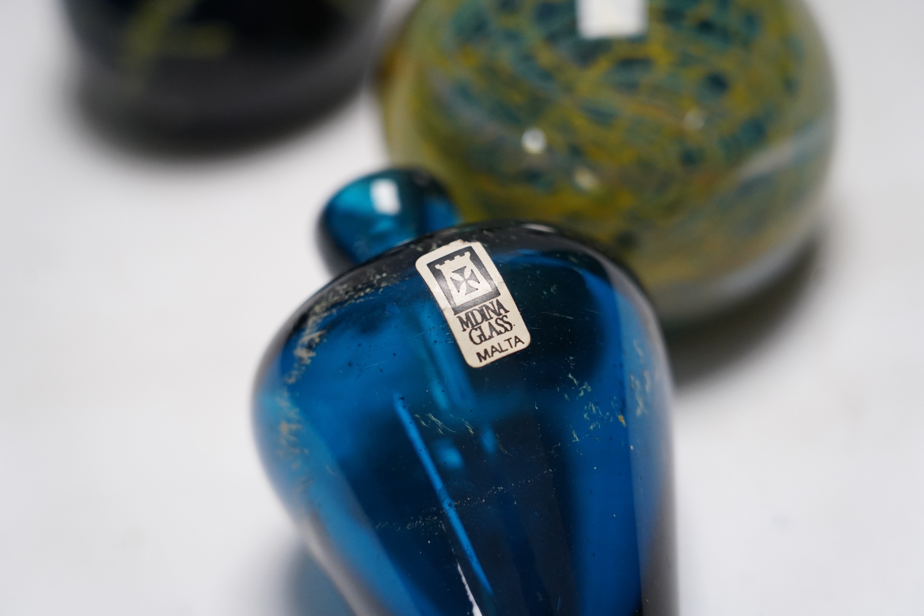 A collection of thirty pieces of Mdina glassware, comprising paperweights and vases, largest 13cm high